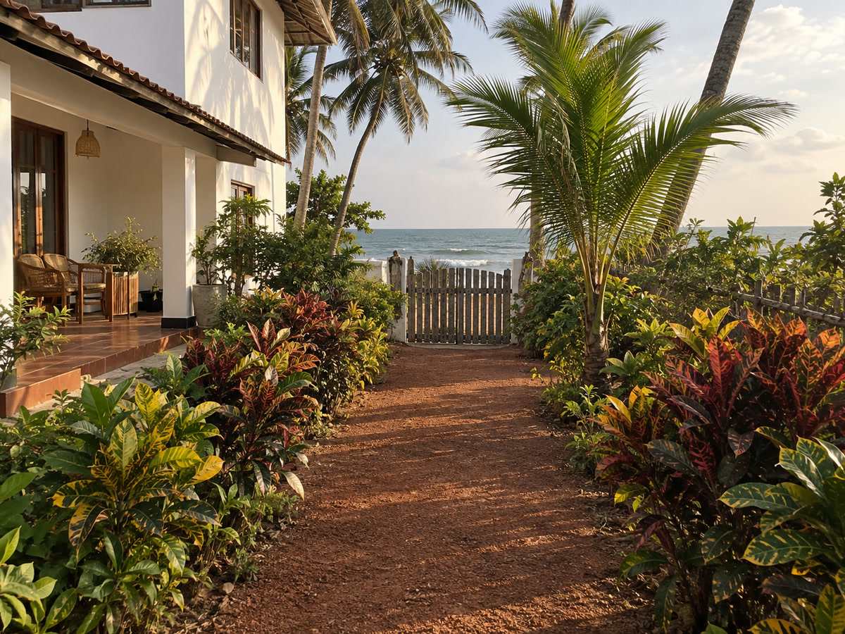 Garden path lined with crotons leading towards the beach gate